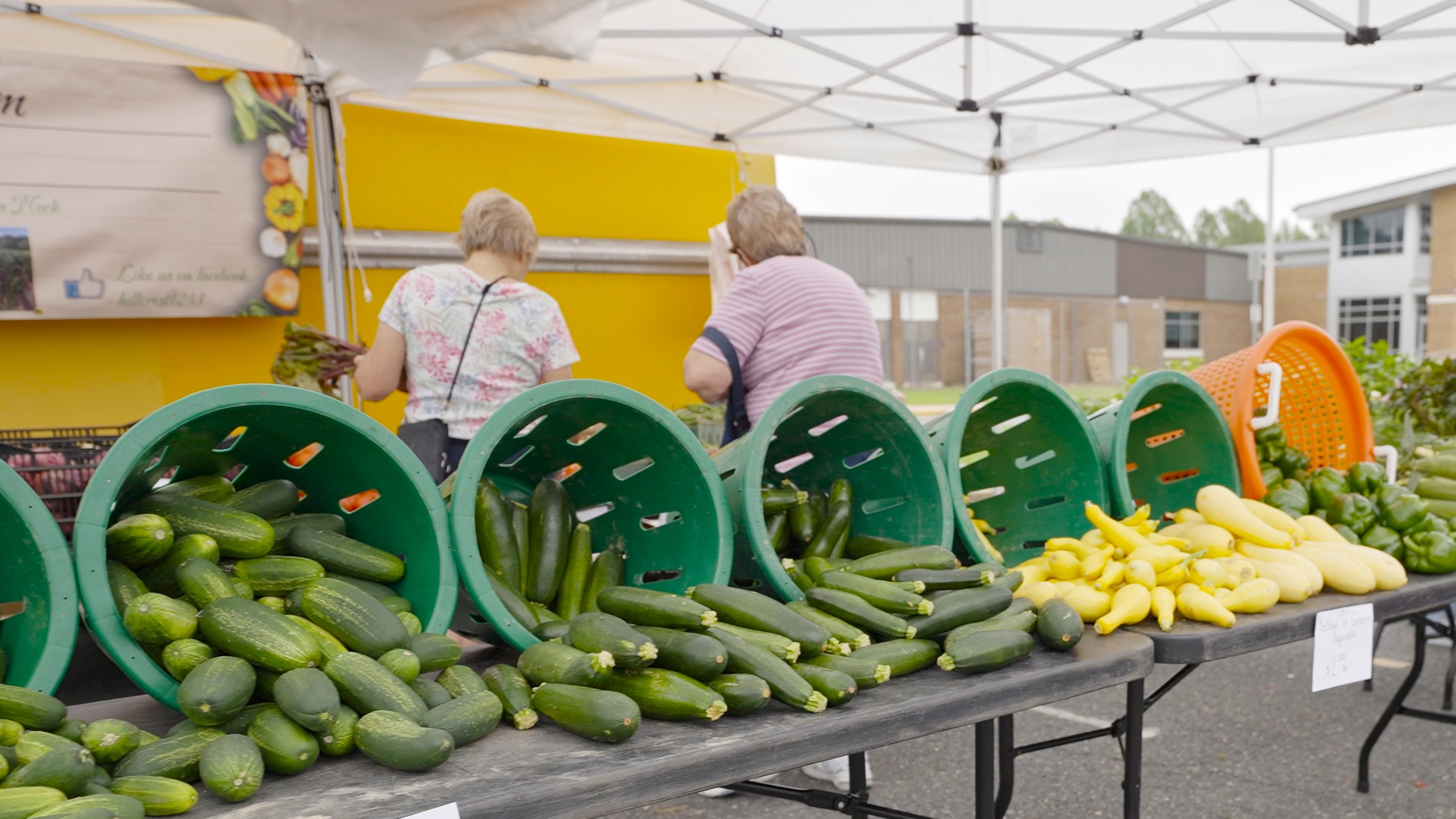 cucumbers and squash sitting out for sale at the King George Farmers Market